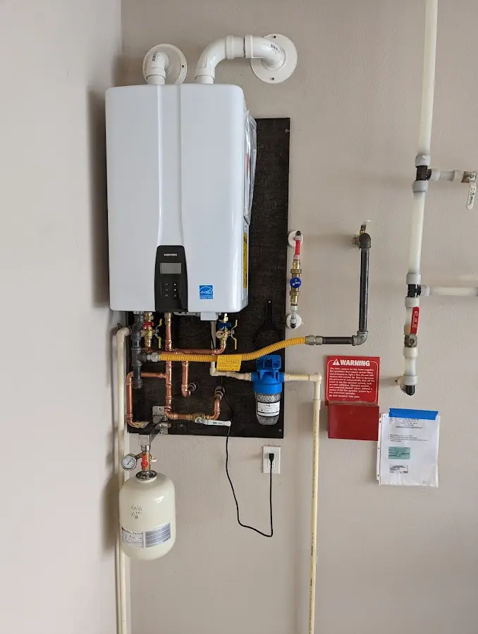 Professional plumber installing copper piping in a Ruscombmanor home